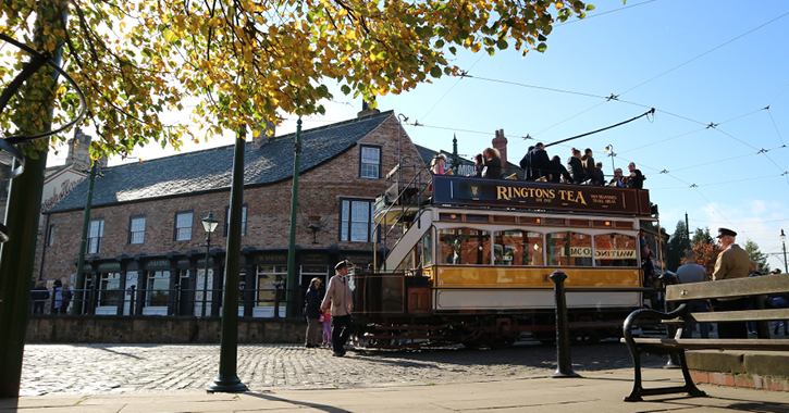 group of people getting ready to ride a traditional tram at Beamish Museum.
